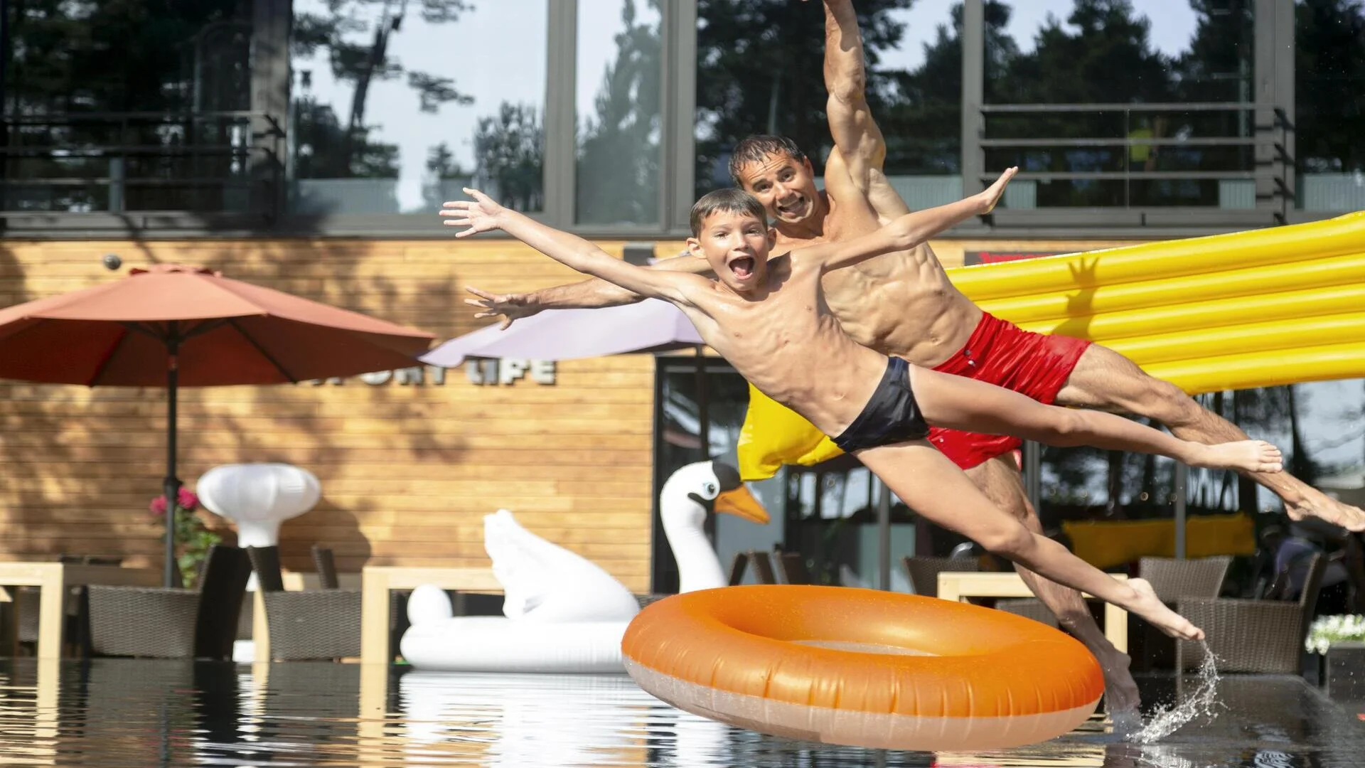 father-son-enjoying-day-swimming-pool-together (1) (1)